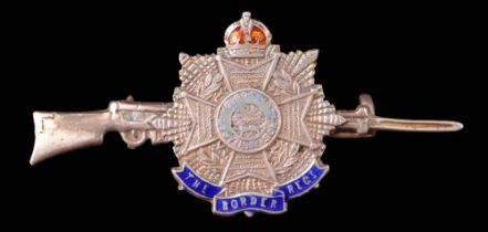 A Great War Border Regiment enamelled white metal sweetheart brooch, in the form of the regimental