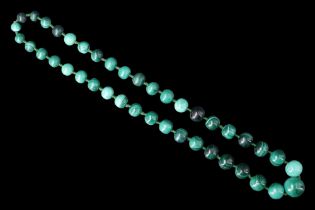 A contemporary graduated malachite bead matinee length necklace, the minerals divided by green glass