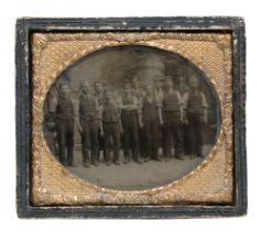 A mid 19th Century daguerreotype depicting a group of workers standing before a building and large