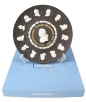 A boxed Wedgwood black Jasperware commemorative plate, diameter 21 cm