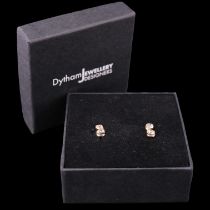 A pair of contemporary diamond earrings, each comprising a vertical pair of brilliant-cut diamonds