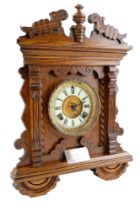A late 19th Century carved oak mantel / shelf clock by The Ansonia Clock Company, having a spring-
