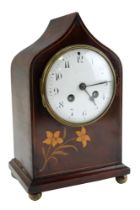 An Edwardian mahogany mantle clock having a barrel movement and striking on a gong, the ogee arch