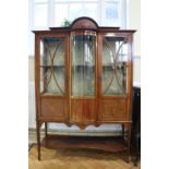 A Sheraton Revival period glazed and marquetry-inlaid mahogany display cabinet, of break bow front