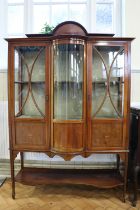 A Sheraton Revival period glazed and marquetry-inlaid mahogany display cabinet, of break bow front