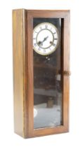 A late 19th Century two-train clock movement in a later glazed case, 56 x 23 x 13 cm