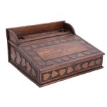 A late 19th / early 20th Century Arts and Crafts influenced carved oak portable desk decorated