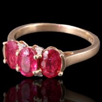 A three-stone natural ruby ring, comprising three oval cut stones each of approx 0.6 ct, bar-and