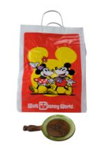 A Walt Disney World wall plaque and bag, former 20 cm