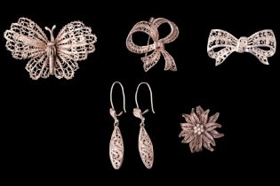 Four filigree white metal brooches together with a similar pair of ear pendants