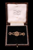 A Victorian pearl brooch, in the form of a pair of ribbon-tied annuli centred by a daisy-like