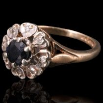 A sapphire and diamond ring, comprising a round-cut sapphire of approx 0.33 cts framed by small