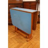 A mid-Century blue Formica topped drop-leaf kitchen table, circa 1950s - 1960s, 75 cm x 119 cm x