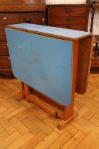 A mid-Century blue Formica topped drop-leaf kitchen table, circa 1950s - 1960s, 75 cm x 119 cm x