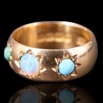 An Edwardian turquoise and opal set 18 ct gold band, comprising a 4.5 mm opal cabochon set between