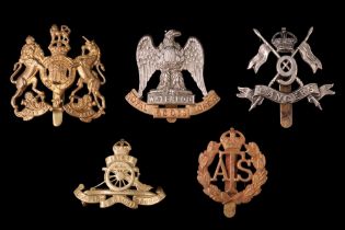A small group of cap badges including a 9th Lancers example