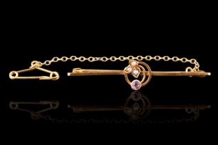 An early 20th Century amethyst, seed pearl and 9 ct gold bar brooch, the amethyst and pearls set