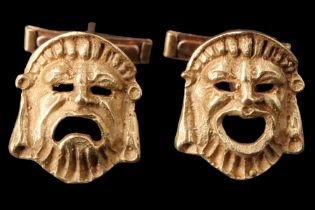 A pair of Greek 18 ct yellow metal theatrical mask cufflinks, respectively modelled in