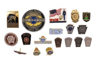 A group of North American collar and lapel badges including Pennsylvania State Police, Marine