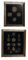 Two framed displays of British army cap and other badges