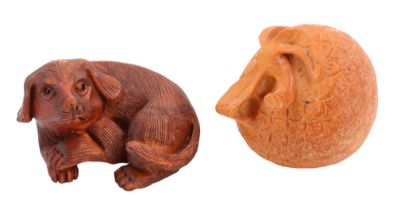 Two mid-to-late 20th Century netsuke carved in depiction of a dog and a lychee repsecively, lychee