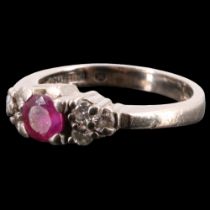 A spinel and white sapphire finger ring, having a round pink spinel of approximately 0.25 carats set