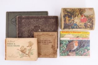 A collection of cigarette and tea cards