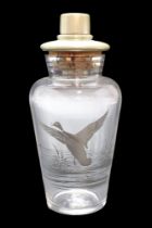 A mid 20th Century silvered glass cocktail shaker decorated in depiction of a duck taking flight, 22