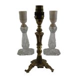 A brass candlestick converted to electricity together with two moulded glass lamps, former 22 cm