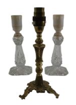 A brass candlestick converted to electricity together with two moulded glass lamps, former 22 cm