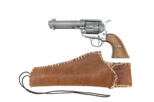 A vintage die-cast (non-firing) replica Colt Peacemaker revolver and leather holster