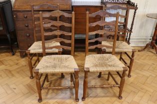 Four late 19th / early 20th Century rush-seated oak ladder-back chairs, 95 cm