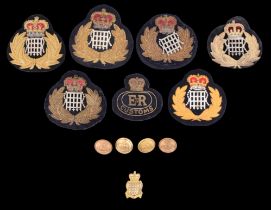A collection of QEII Customs and Excise cap badges together with four buttons