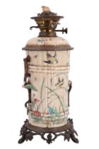 A Victorian Chinoiserie porcelain oil lamp, the reservoir and columnar stand in the form of