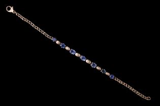 A sapphire and diamond bracelet, having seven graduated oval sapphires of approximately 3 carats
