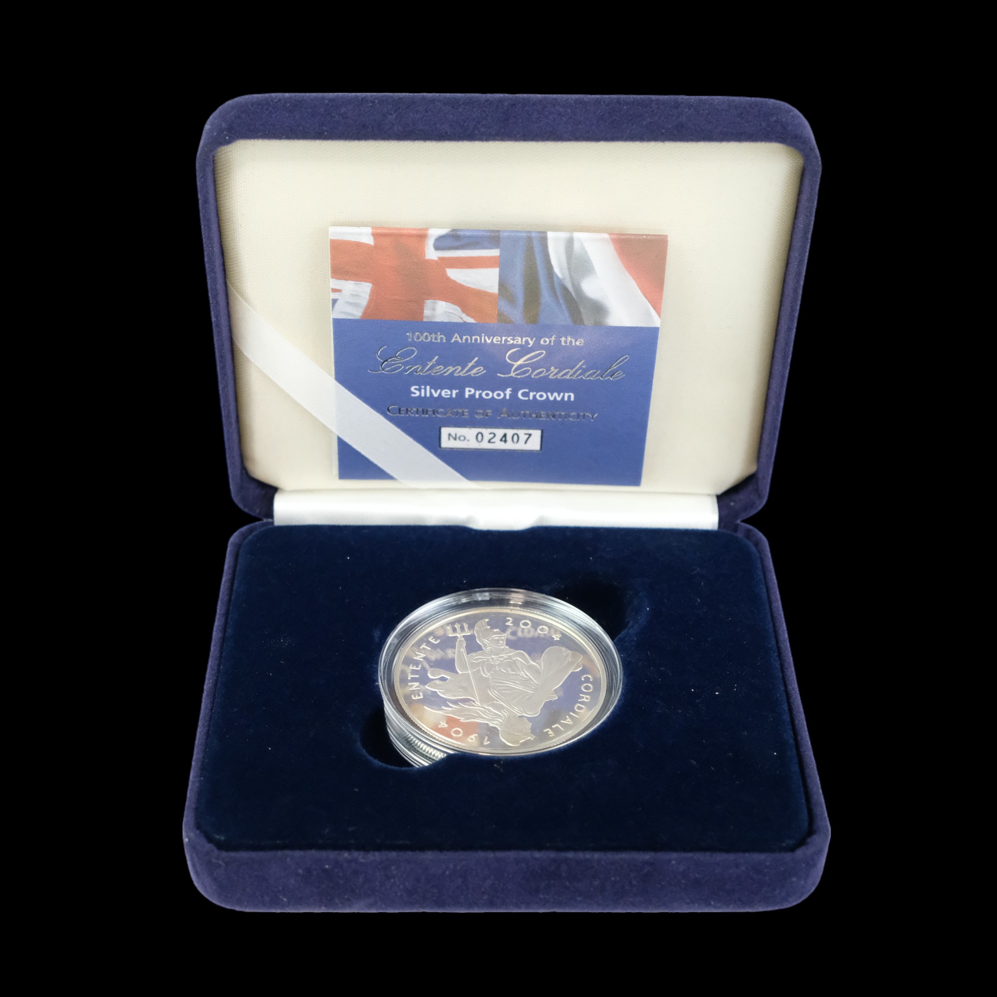 A cased Royal Mint silver proof crown commemorating the 100th anniversary of the Entente Cordiale