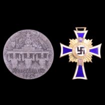 A German Third Reich Mother's Cross in gold, together with a 1937 Reichsparteitag day badge