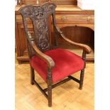 A Victorian Flemish style carved oak armchair, 110 cm high