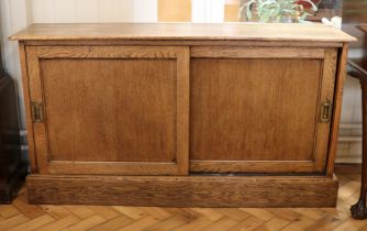 A late 19th / early 20th Century office oak and pine sliding-door cabinet, 128 cm x 30 cm x 70 cm