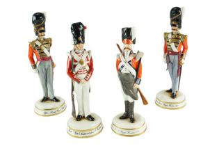 Four Michael Sutty limited-edition hand-painted porcelain military figurines comprising "Officer,