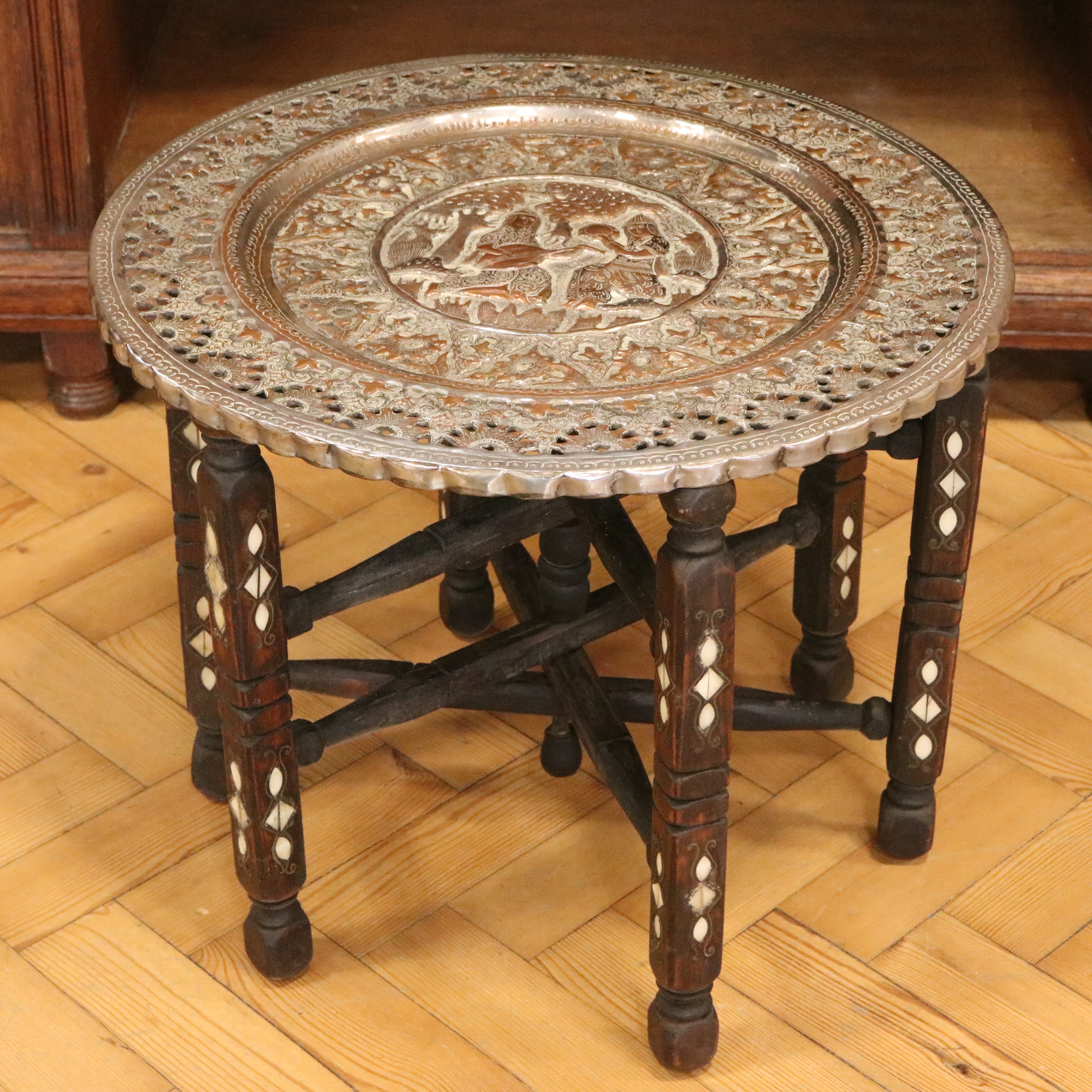 An early-to-mid 20th Century Persian copper-topped and mother-of-pearl inlaid folding table, 52 cm x