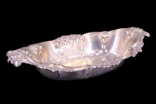 An Edwardian silver dish, of fancy lobed oval form, having an everted C-scroll and floral rim, Jones