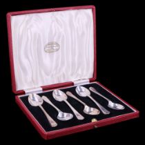 A cased set of 1930s six silver tea spoons, their terminals relief decorated with two crossed gold