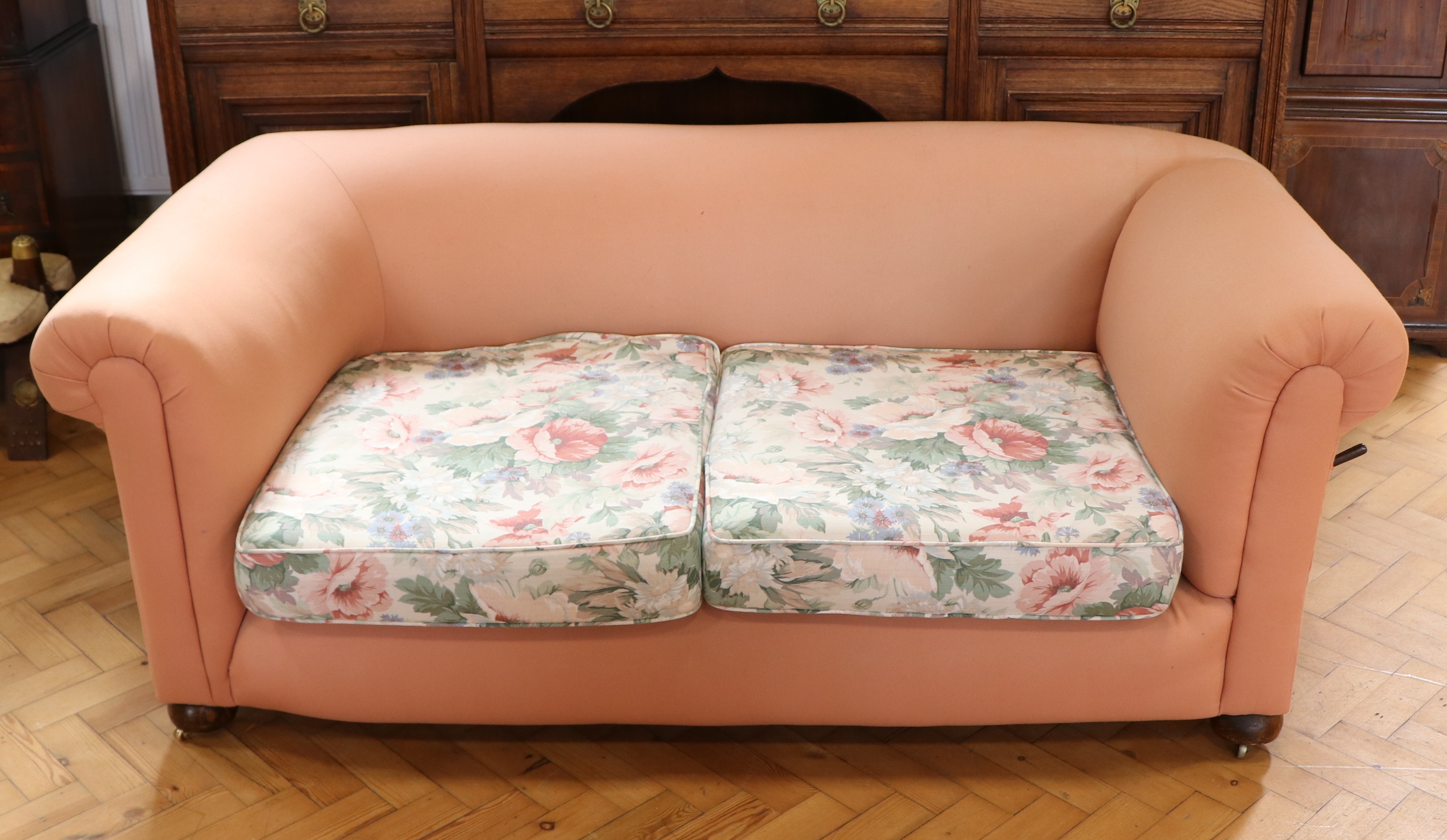 A re-upholstered early 20th Century two-seater Chesterfield drop-arm sofa, 170 cm x 85 cm x 67 cm