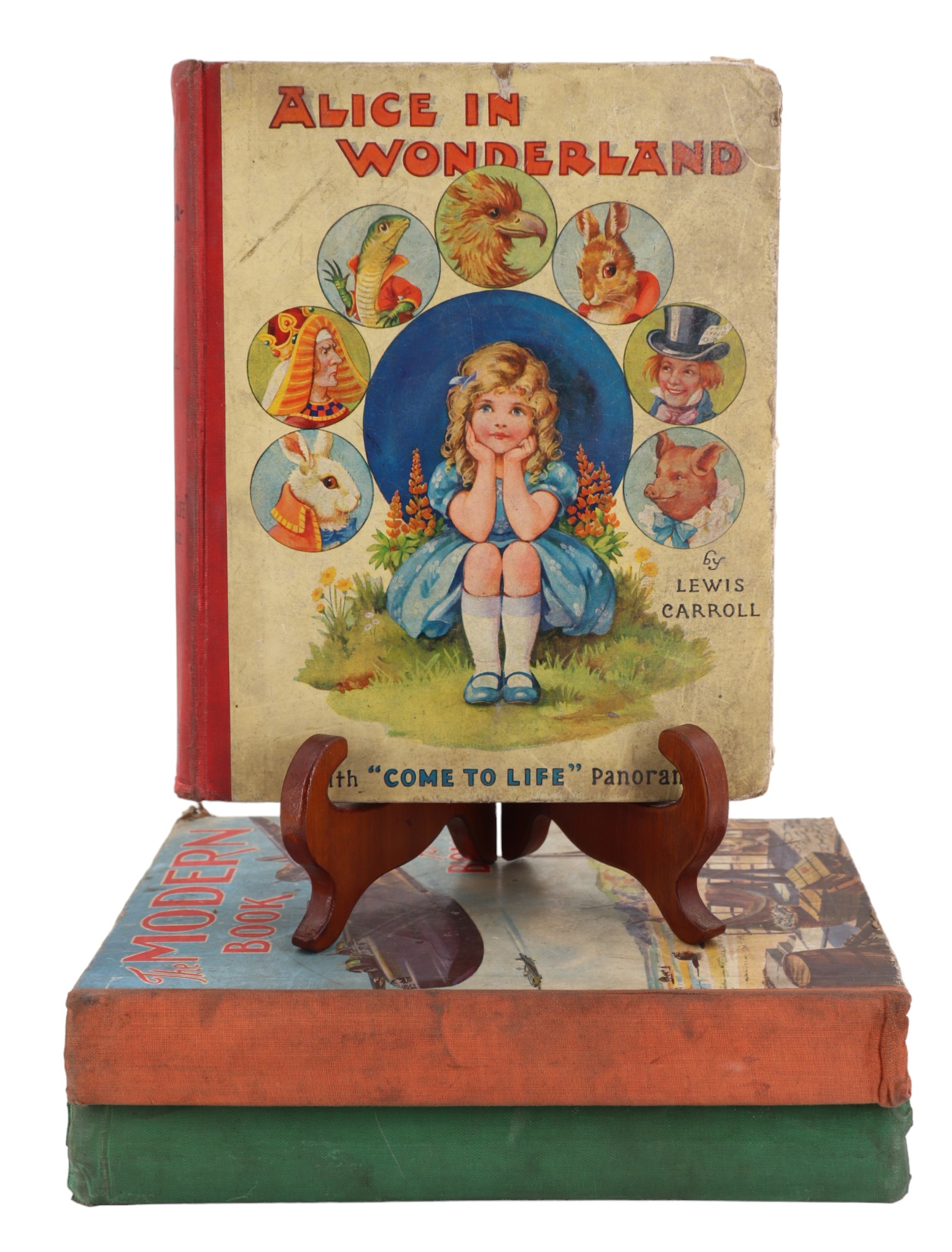 Three vintage children's annuals including Alice in Wonderland, Champion Book for Boys, etc