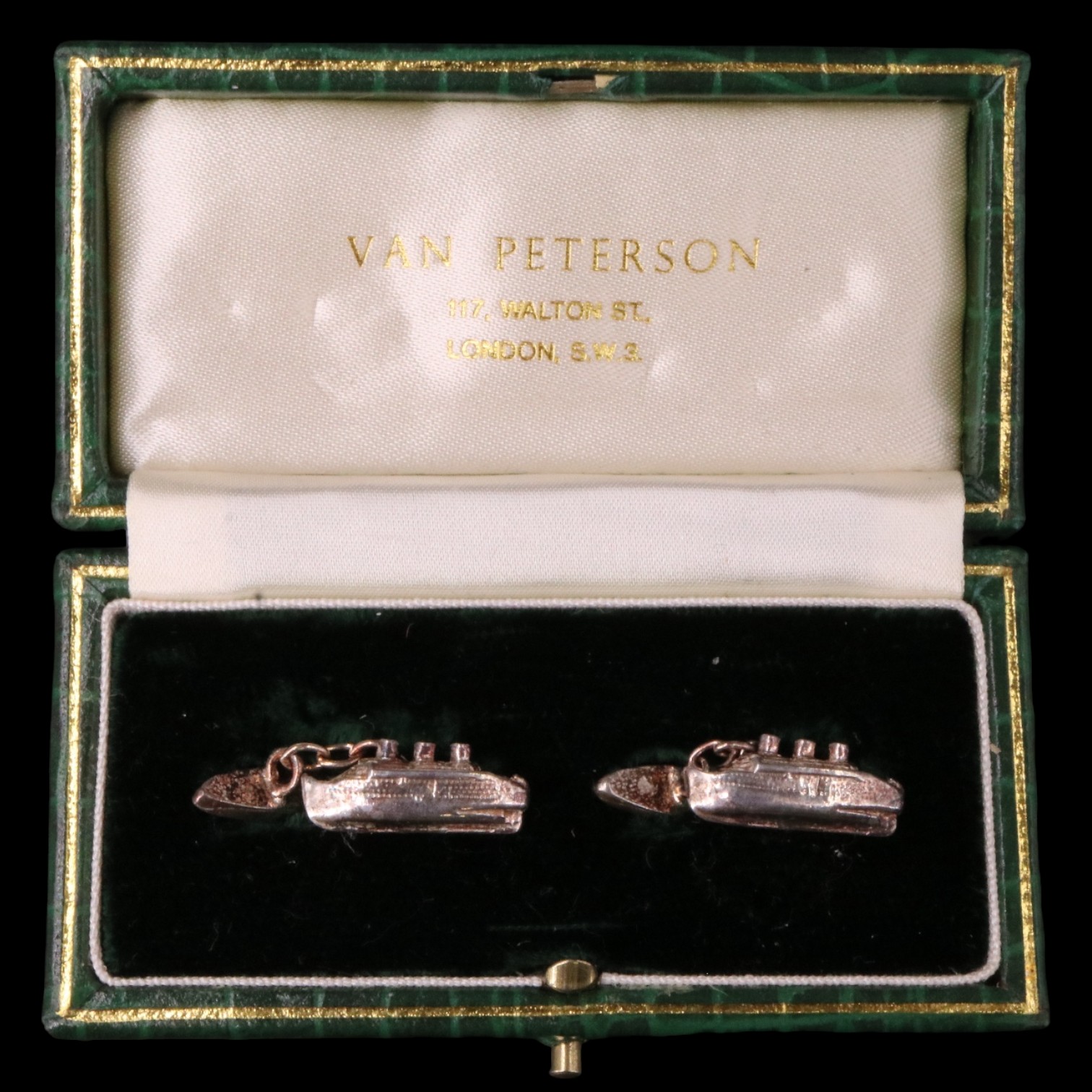 A pair of boxed Van Peterson white metal cufflinks modelled as cruise ships, stamped "STERLING",