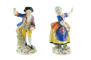 A pair of reproduction 18th Century Chelsea porcelain figurines respectively of a belle and beau