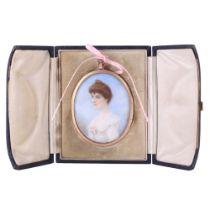 A portrait miniature of an Edwardian lady, having coifed reddish hair and portrayed wearing a