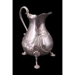 A Victorian silver baluster cream jug, bearing finely chased and engraved blossom decoration