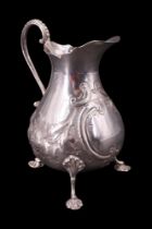 A Victorian silver baluster cream jug, bearing finely chased and engraved blossom decoration